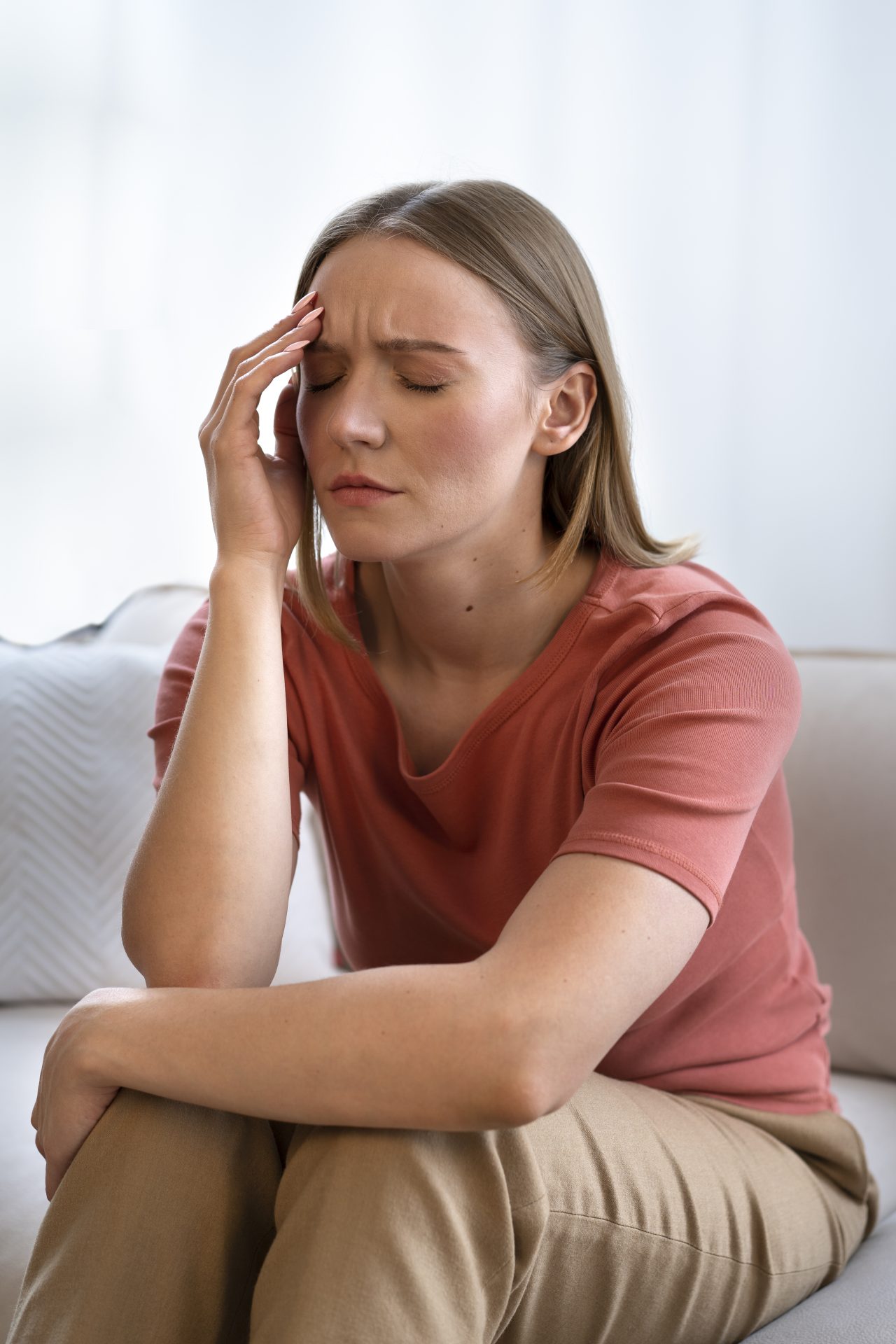 Woman sitting on sofa looking anxious or stressed
